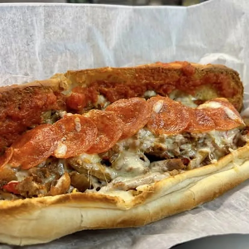 Pizza Steak — grilled steak, pepperoni, marinara, melted cheese on a garlic-bread bun